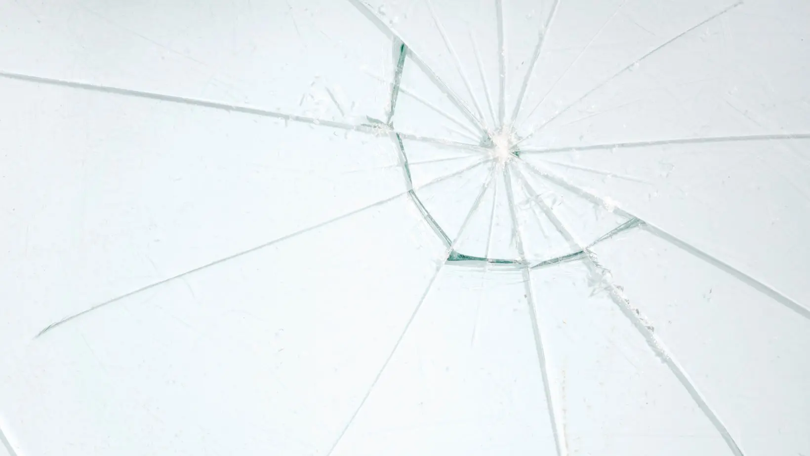 Close-up of a cracked residential window, highlighting the need for repair or replacement. Empire Contractors LLC provides professional window repair and installation services in Cincinnati, OH, and surrounding areas.