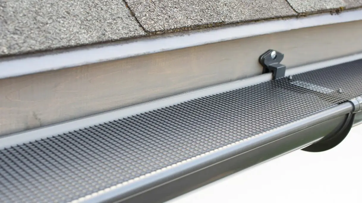 Close-up of a professional gutter cleaning system in action, removing leaves and debris from a residential gutter. Empire Contractors LLC offers expert gutter cleaning and maintenance services in Cincinnati, OH, and surrounding areas to protect homes from water damage.