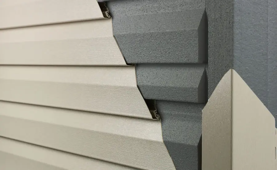 Close-up of insulated vinyl siding with a cutaway view showing foam backing for enhanced energy efficiency and durability. Insulated siding improves home insulation, reduces energy costs, and enhances curb appeal. Empire Contractors specializes in high-quality siding installation for long-lasting protection.