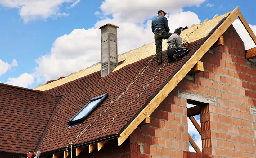 Roofers lay and install asphalt shingles. Roof repair with two roofers. Roofing construction with roof tiles, asphalt shingles.