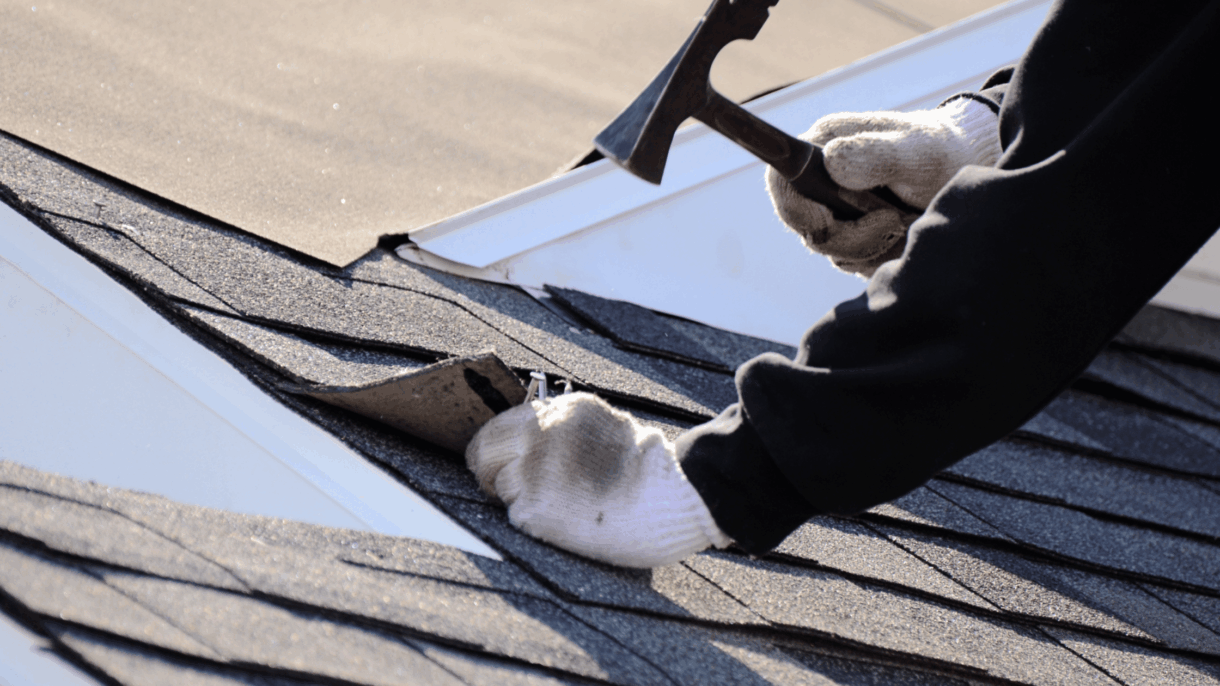 Worker in white gloves inspecting asphalt shingle roof for storm damage and missing shingles during roof inspection